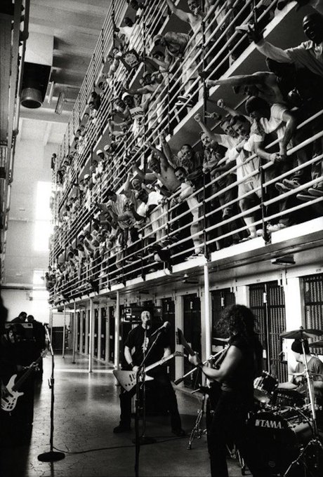 Metallica performs behind prison walls in 2003, with inmates filling the tiers above.